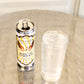 A can of Five Saints Rooftop Lemonade stands next to a clear glass filled with the cocktail stands on a metallic surface