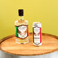 A bottle of Five Saints Savory Tuscan Style Gin and a can of Five Saints Gin & Tonic are displayed side-by-side on a wooden barrel against a solid yellow-green background.